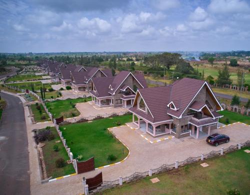 an aerial view of a large house with a car at Takimu Villas Thika in Thika