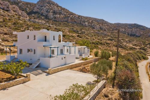 an aerial view of a house with mountains in the background at Albatros Studios & Apartments in Lefkos Karpathou