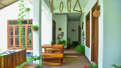 a hallway of a house with a wooden table at Menara Green Inn in Dambulla