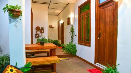 a corridor of a house with a wooden door at Menara Green Inn in Dambulla
