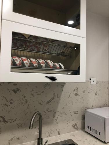 a kitchen with an oven with food inside of it at Gold Coast Luxury Apartment Nha Trang in Nha Trang