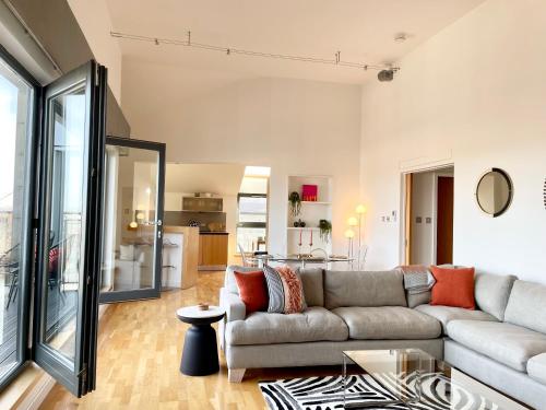 a living room with a couch and a table at Edinburgh Penthouse 101 in Edinburgh