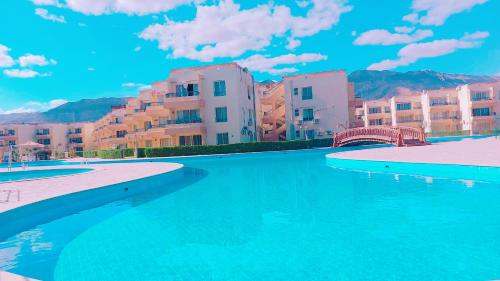 a pool of water in front of some buildings at Chalet in Blumar El Dome for families only in Ain Sokhna
