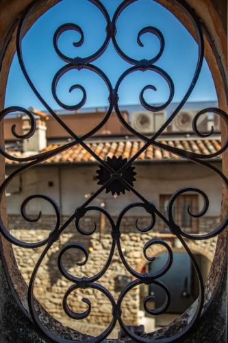 a iron gate with a view of a building at Hotel Degli Oleandri in Sirmione