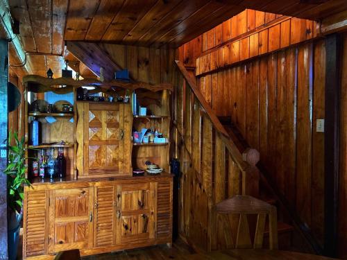 a room with wooden walls and a staircase in a cabin at Dagdag Village Homestay - Sagada in Sagada