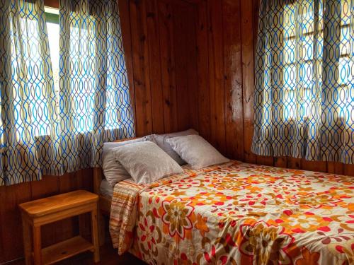 a bedroom with a bed with a colorful blanket at Dagdag Village Homestay - Sagada in Sagada