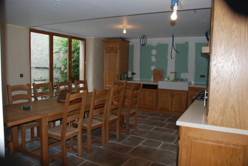 a kitchen and dining room with a table and chairs at La Petite Maison des Montagnes in Luz-Saint-Sauveur