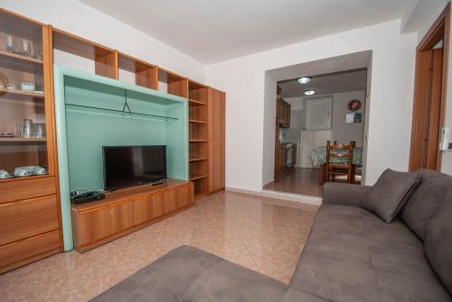 a living room with a couch and a flat screen tv at Luxury Seaview Apartments Manarola by Arbaspàa in Manarola