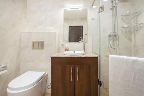 a bathroom with a toilet and a sink and a shower at Deluxe apartment in The city center 2 rooms in Yerevan