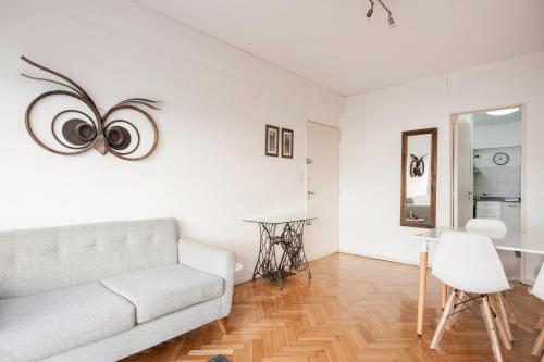 Sala de estar blanca con sofá y mesa en Apartment San Telmo en Buenos Aires