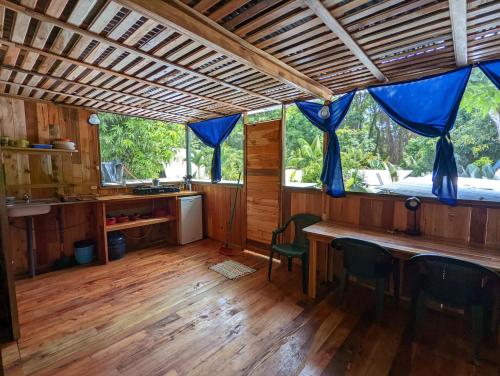 a kitchen with a table and chairs in a house at Arboura Eco Cabins in Uvita
