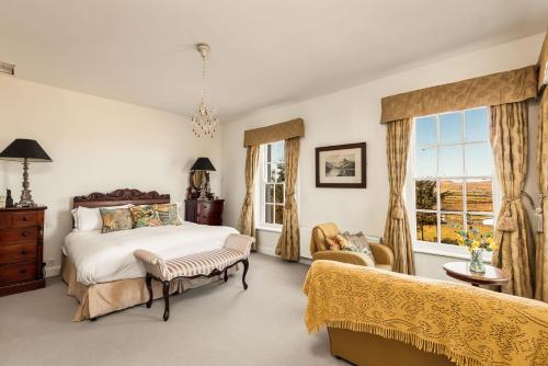 a bedroom with a bed and a window at Granville House Apartments and Garden Suites in Ballyferriter