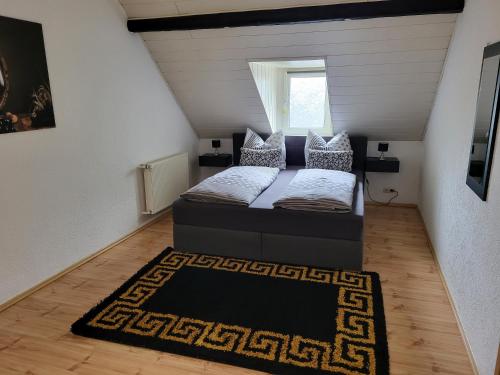 a small bedroom with a bed and a rug at Haus Mika in Cochem