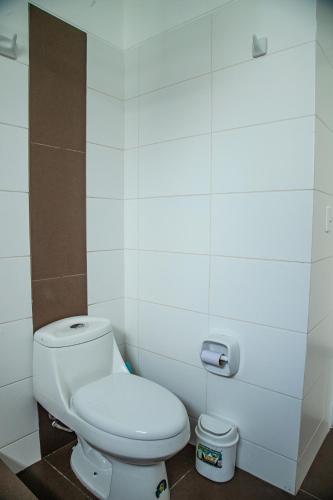 a bathroom with a white toilet in a room at Condominio Nuevo Paracas in Paracas