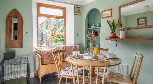 a dining room with a table and chairs at Quirky Kendal Cottage in Kendal
