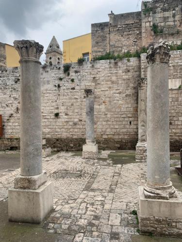 two columns in front of a brick wall at Porto Antico in Bari