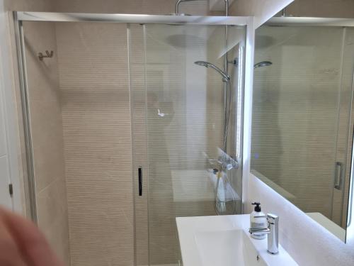 a bathroom with a shower and a sink and a mirror at Hany apartment Ducado 2-I in Benidorm