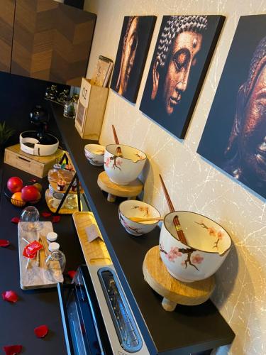 a counter with bowls on top of it at Loveroom intimiste et haut de gamme à 30 min de Toulouse in Lagrâce-Dieu