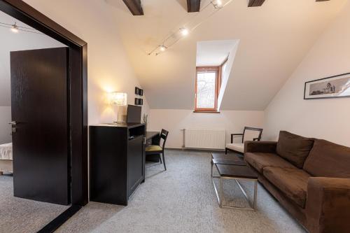 a living room with a couch and a table at Bazilika alatt Panzió in Esztergom