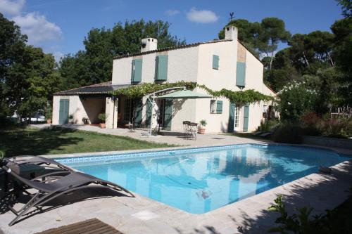 a swimming pool in front of a house at Ecole Buissonnière in Antibes