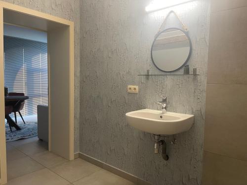 a bathroom with a sink and a mirror on the wall at Parel van Bever - Perle de Biévène in Bever