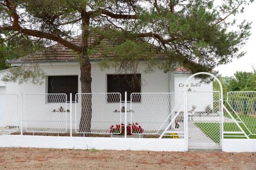 a white fence in front of a house at Dve kuce pored jezera in Palić