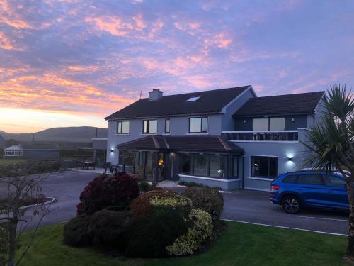 a house with a car parked in front of it at Cill Bhreac House B&B in Dingle