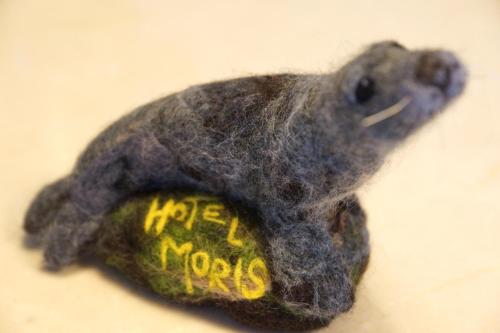 a stuffed dog toy with a frisbee in its mouth at Moris Boutique Beach Hotel in Gdańsk