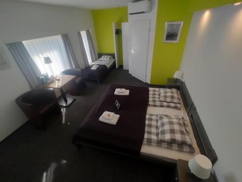 a room with a bed and a couch and a living room at RJ Hotel in Pabianice