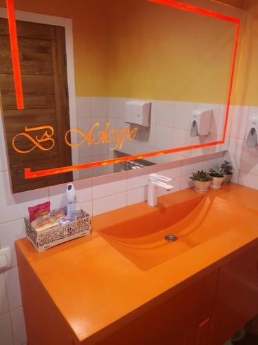 a bathroom with a wooden sink and a mirror at Ayhan Hotel in Aktobe