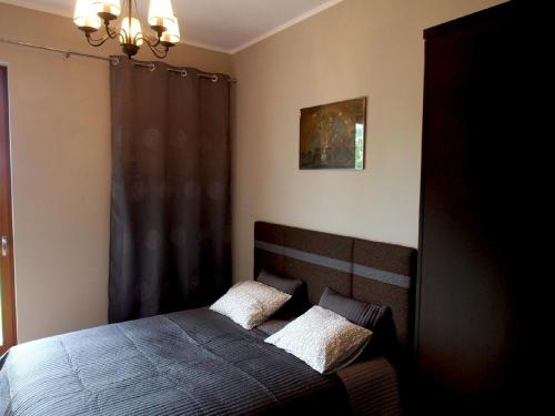 a bedroom with a bed with two pillows on it at Apartament Orlowo in Gdynia