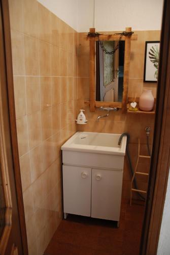 a bathroom with a white sink and a mirror at Cà Mia in Nus