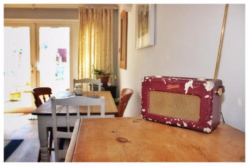 a suitcase sitting on top of a wooden table at Self Contained Flat with Private Garden & Parking in Sandown