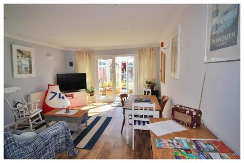 a living room with a couch and a table at Self Contained Flat with Private Garden & Parking in Sandown