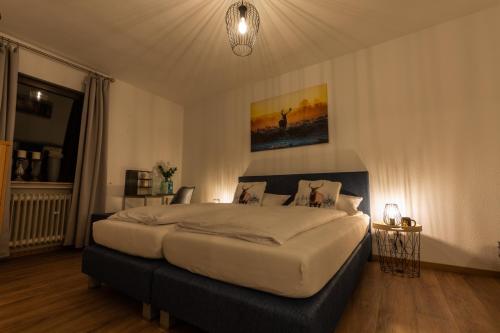 a bedroom with a large bed in a room at Hotel & Restaurant Zum Ochsen -Ox Distillery in Hösbach