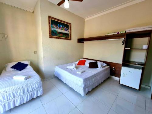 Cama ou camas em um quarto em Pousada Aconchego
