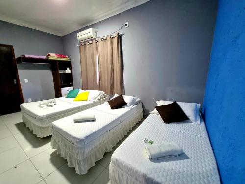 Cama ou camas em um quarto em Pousada Aconchego