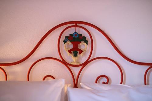 a bed with a red head board with a mirror at Quinta do Monte Travesso - Country Houses & Winery in Tabuaço