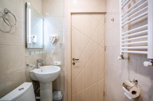 a small bathroom with a sink and a toilet at Eltisy Guest House in Kazbegi