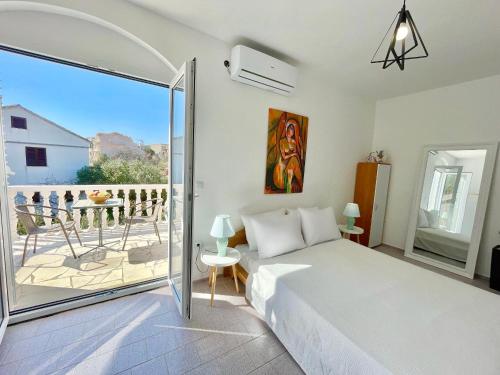 a bedroom with a bed and a balcony at Sea View Apartment Amaro in Korčula