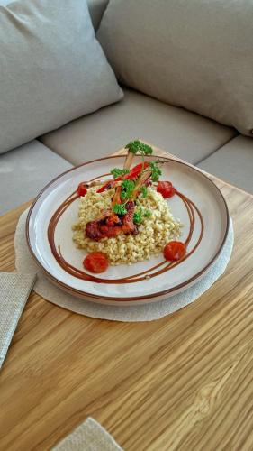a plate of rice and vegetables on a table at Ayhan Hotel in Aktobe