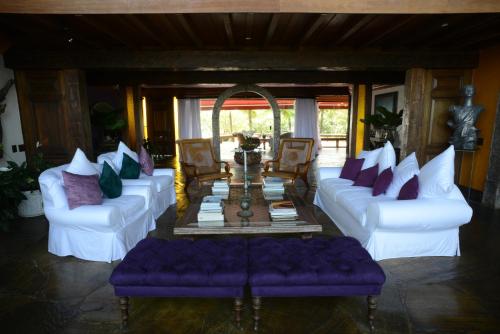 
a living room filled with furniture and a couch at Le Chateaux Joá Boutique Hotel in Rio de Janeiro
