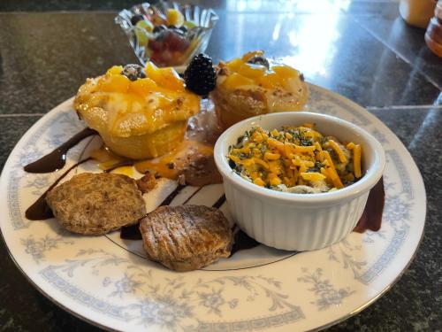 a plate of food with pastries and a bowl of food at Peace & Plenty Inn Bed and Breakfast Downtown St Augustine-Adults Only in Saint Augustine