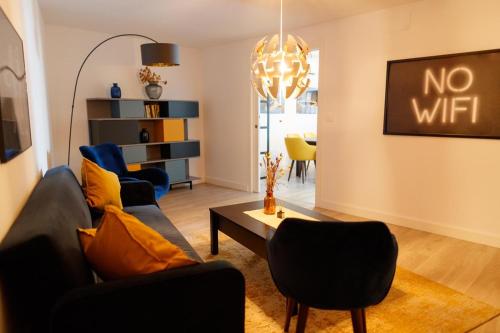 a living room with a couch and a table at Casa Aire de Mar, modern house with private pool, overlooking Baviera golf, within walking distance of beach in Vélez-Málaga