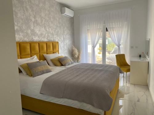 a bedroom with a large bed and a balcony at River Luxury House in Bihać