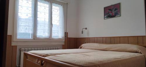 a bed in a room with a window at Eden 22 in Camporosso