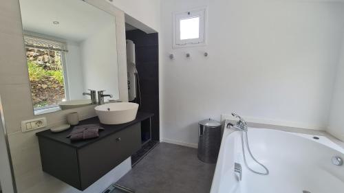 a white bathroom with a tub and a sink at Casa Villamaravilla II, Isla de El Hierro in Frontera