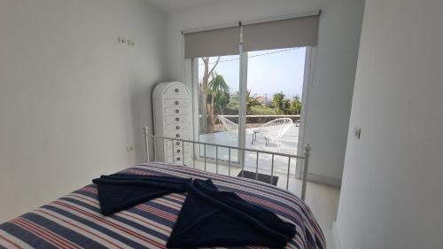 a bedroom with a bed and a balcony with a view at Casa Villamaravilla II, Isla de El Hierro in Frontera