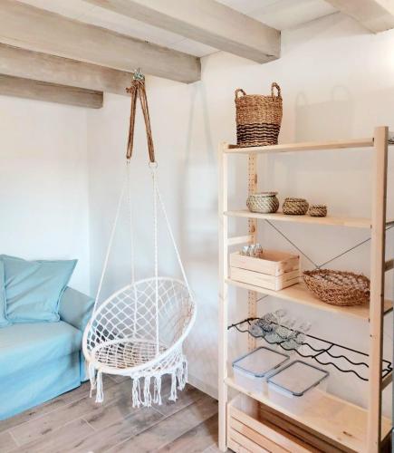 a room with a hammock hanging from the ceiling at Seaside cottage 'Little white port' in Lučica