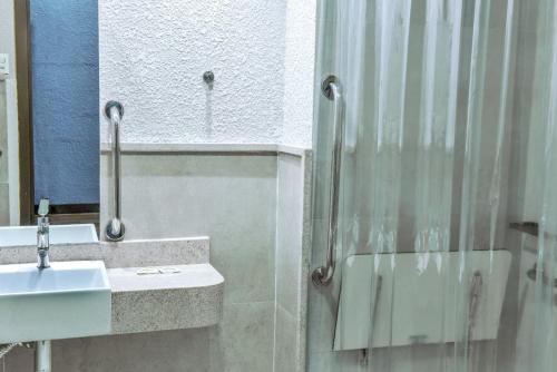 a bathroom with a sink and a shower at Days Inn By Wyndham Cascavel in Cascavel